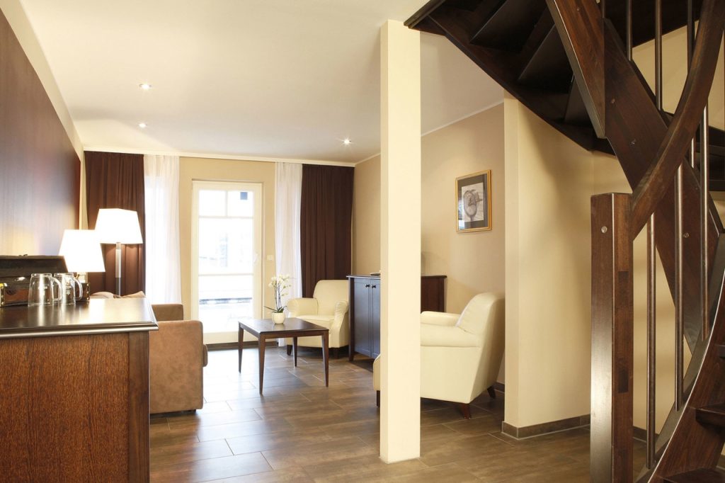 Comfortable double room with a balcony view at Precise Resort Hafendorf Rheinsberg.
