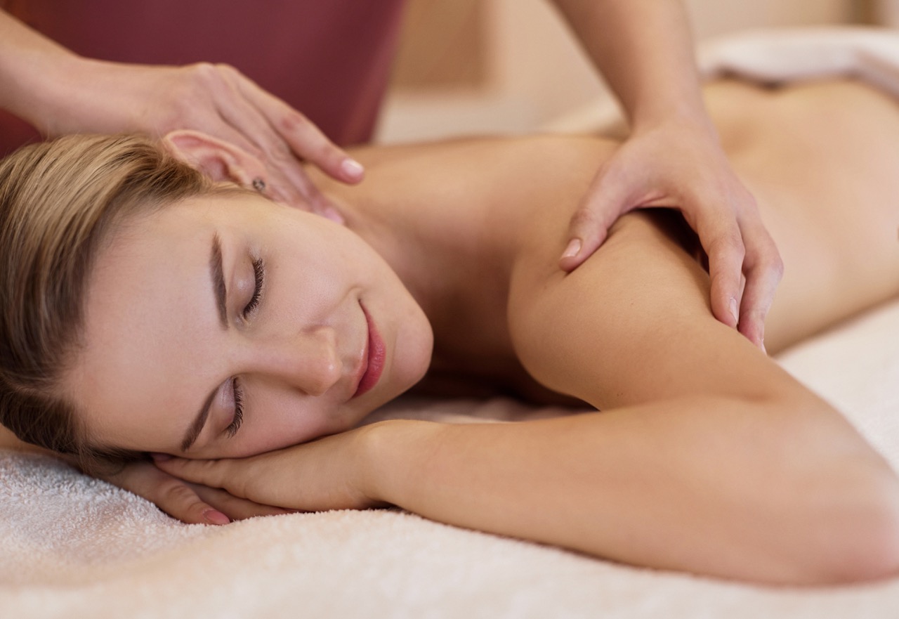 A person receives a professional massage in a tranquil spa environment.