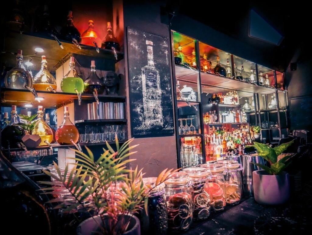 Cozy interior of Wash Bar in Berlin Mitte, featuring communal seating and washing machines in the background.